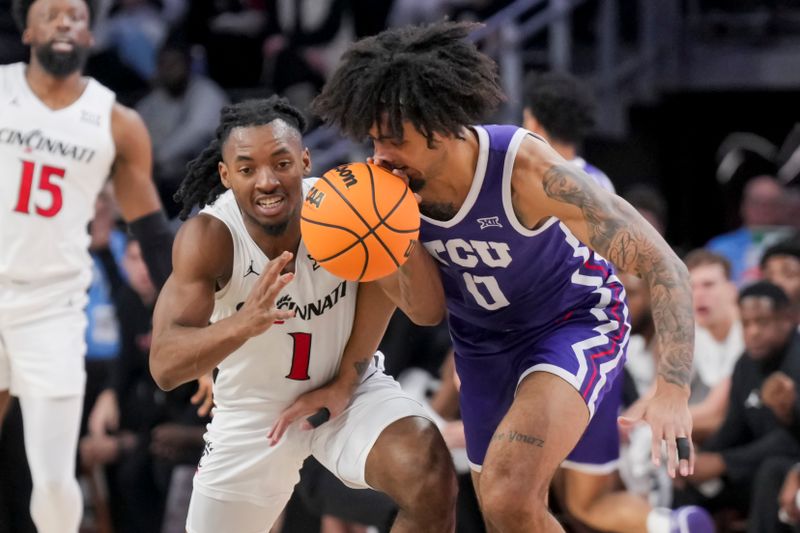 Jan 16, 2024; Cincinnati, Ohio, USA;  Cincinnati Bearcats guard Day Day Thomas (1) reaches for the loose ball against TCU Horned Frogs guard Micah Peavy (0) in the first half at Fifth Third Arena. Mandatory Credit: Aaron Doster-USA TODAY Sports