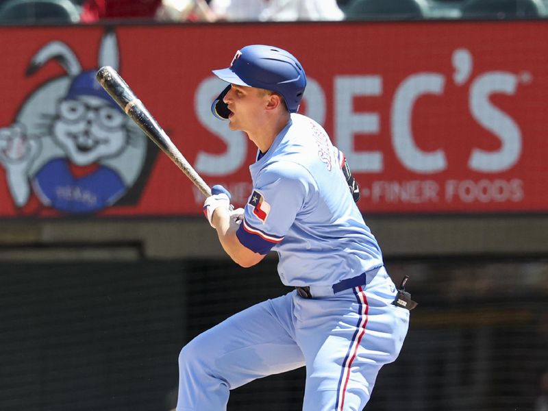 May 4, 2025; Arlington, Texas, USA;  Texas Rangers shortstop Corey Seager (5) hits a two-run single during the third inning against the Seattle Mariners at Globe Life Field. Mandatory Credit: Kevin Jairaj-Imagn Images