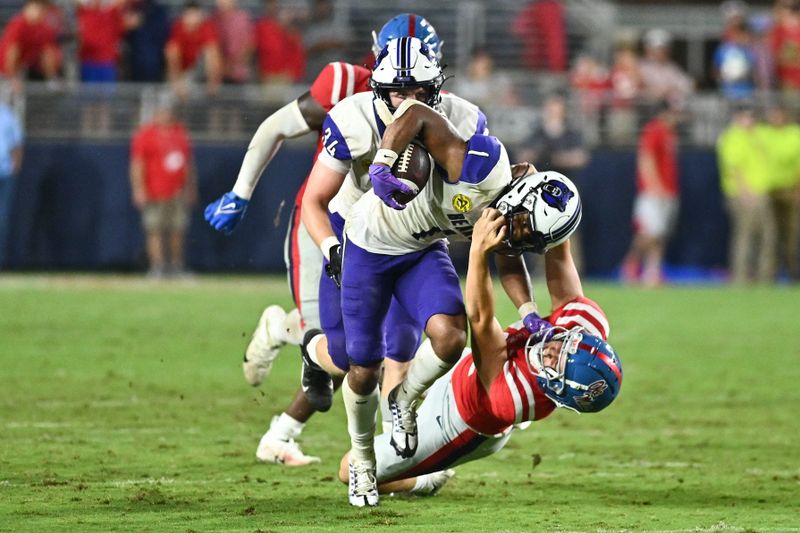 Sep 10, 2022; Oxford, Mississippi, USA; Central Arkansas Bears wide receiver Jarrod Barnes (1) runs the ball against Ole Miss Rebels punter Fraser Masin (12) during the fourth quarter at Vaught-Hemingway Stadium. Mandatory Credit: Matt Bush-USA TODAY Sports