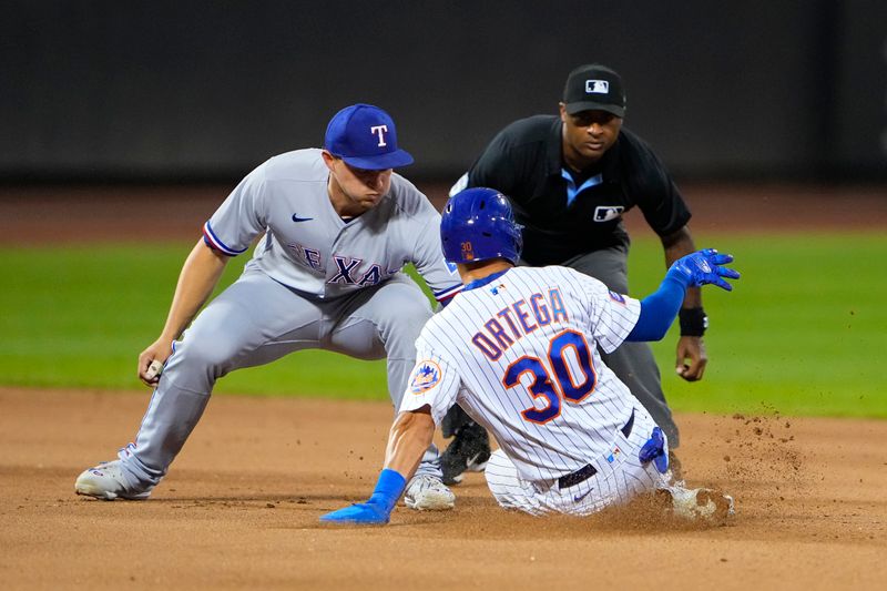 Aug 30, 2023; New York City, New York, USA;  New York Mets left fielder Rafael Ortega (30) is tagged out attempting to steal second base by Texas Rangers shortstop Corey Seager (5) after catching the throw during the fourth inning at Citi Field. Mandatory Credit: Gregory Fisher-USA TODAY Sports