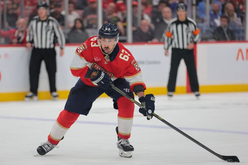 May 9, 2025; Sunrise, Florida, USA; Florida Panthers center Brad Marchand (63) moves the puck against the Toronto Maple Leafs during overtime in game three of the second round of the 2025 Stanley Cup Playoffs at Amerant Bank Arena. Mandatory Credit: Sam Navarro-Imagn Images