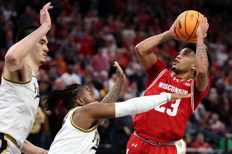 Mar 16, 2024; Minneapolis, MN, USA; Wisconsin Badgers guard Chucky Hepburn (23) shoots as Purdue Boilermakers guard Lance Jones (55) defends during the second half at Target Center. Mandatory Credit: Matt Krohn-USA TODAY Sports