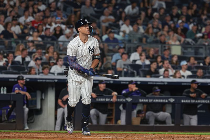 Aug 23, 2024; Bronx, New York, USA;  New York Yankees designated hitter Giancarlo Stanton (27) hits a solo home run during the fourth inning against the Colorado Rockies at Yankee Stadium. Mandatory Credit: Vincent Carchietta-USA TODAY Sports