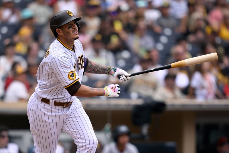 Aug 19, 2023; San Diego, California, USA; San Diego Padres designated hitter Manny Machado (13) hits a home run against the Arizona Diamondbacks during the eighth inning at Petco Park. Mandatory Credit: Orlando Ramirez-USA TODAY Sports