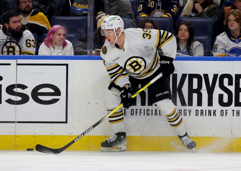 Dec 27, 2023; Buffalo, New York, USA;  Boston Bruins center Morgan Geekie (39) looks to make a pass during the third period against the Buffalo Sabres at KeyBank Center. Mandatory Credit: Timothy T. Ludwig-USA TODAY Sports