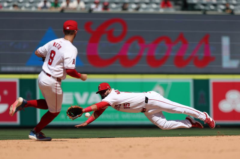 Jun 26, 2024; Anaheim, California, USA;  Los Angeles Angels second baseman Luis Guillorme (15) dives for the ball on a base hit by Oakland Athletics designated hitter Brent Rooker (25, not pictured) during the eighth inning at Angel Stadium. Mandatory Credit: Kiyoshi Mio-USA TODAY Sports