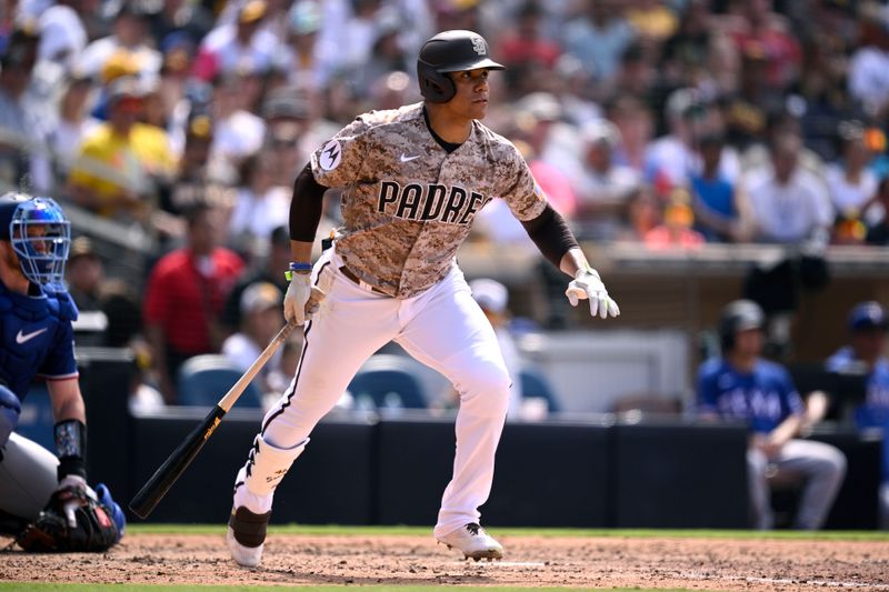 Jul 30, 2023; San Diego, California, USA; San Diego Padres left fielder Juan Soto (22) hits a single against the Texas Rangers during the sixth inning at Petco Park. Mandatory Credit: Orlando Ramirez-USA TODAY Sports