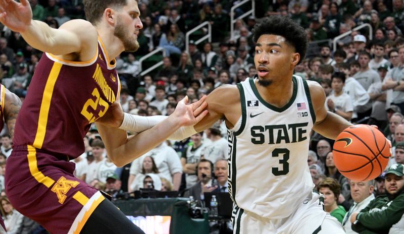 Jan 28, 2025; East Lansing, Michigan, USA;  Michigan State Spartans guard Jaden Akins (3) works around Minnesota Golden Gophers forward Parker Fox (23) during the second half at Jack Breslin Student Events Center. Mandatory Credit: Dale Young-Imagn Images
