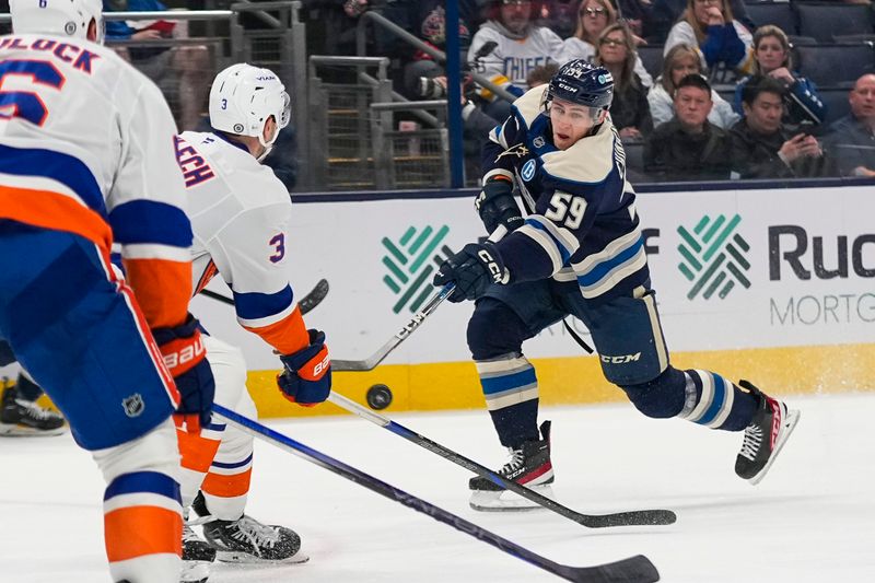 Oct 30, 2024; Columbus, Ohio, USA; Columbus Blue Jackets right wing Yegor Chinakhov (59) shoots the puck against the New York Islanders in the first period at Nationwide Arena. Mandatory Credit: Samantha Madar-Imagn Images