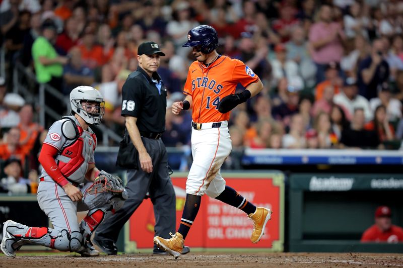 May 9, 2025; Houston, Texas, USA; Houston Astros second baseman Mauricio Dubon (14) crosses home plate to score  a run against the Cincinnati Reds during the fifth inning at Daikin Park. Mandatory Credit: Erik Williams-Imagn Images