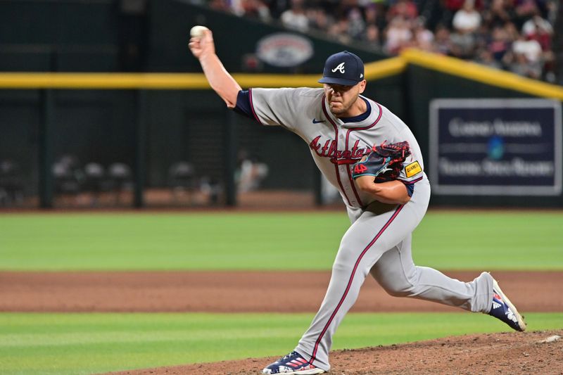 Jul 10, 2024; Phoenix, Arizona, USA;  Atlanta Braves pitcher Joe Jiménez (77) throws in the eighth inning against the Arizona Diamondbacks at Chase Field. Mandatory Credit: Matt Kartozian-USA TODAY Sports