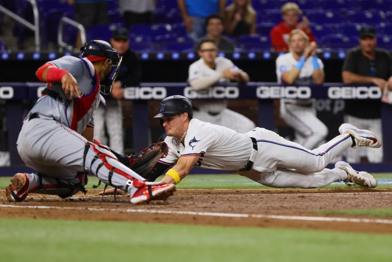 Sep 4, 2024; Miami, Florida, USA; Miami Marlins right fielder Griffin Conine (56) slides at home plate and scores after a double by catcher Nick Fortes (not pictured) against the Washington Nationals during the sixth inning at loanDepot Park. Mandatory Credit: Sam Navarro-Imagn Images