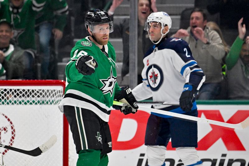 Feb 29, 2024; Dallas, Texas, USA; Dallas Stars center Joe Pavelski (16) celebrates a goal as Winnipeg Jets defenseman Dylan DeMelo (2) looks on during the first period at the American Airlines Center. Mandatory Credit: Jerome Miron-USA TODAY Sports