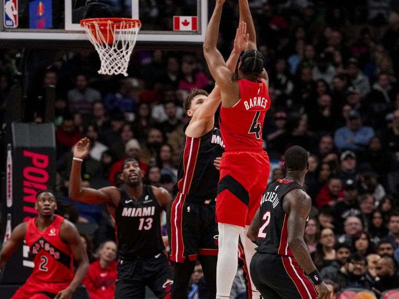 TORONTO, ON - DECEMBER 1: Scottie Barnes #4 of the Toronto Raptors shoots the ball against Pelle Larsson #9 of the Miami Heat at Scotiabank Arena on December 1, 2024 in Toronto, Ontario, Canada. NOTE TO USER: User expressly acknowledges and agrees that, by downloading and/or using this Photograph, user is consenting to the terms and conditions of the Getty Images License Agreement. (Photo by Andrew Lahodynskyj/Getty Images)