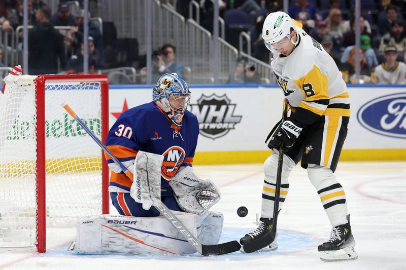 Nov 5, 2024; Elmont, New York, USA; New York Islanders goaltender Ilya Sorokin (30) makes a save against Pittsburgh Penguins left wing Michael Bunting (8) during the third period at UBS Arena. Mandatory Credit: Brad Penner-Imagn Images