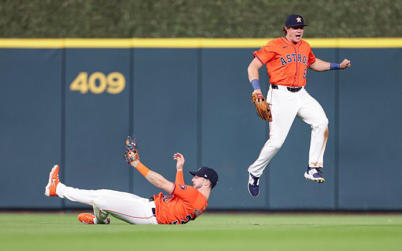 Apr 12, 2024; Houston, Texas, USA; Houston Astros center fielder Jake Meyers (6) leaps as right fielder Kyle Tucker (30) makes a sliding catch during the fifth inning against the Texas Rangers at Minute Maid Park. Mandatory Credit: Troy Taormina-USA TODAY Sports