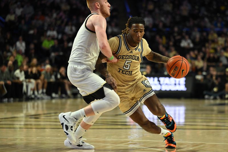 Feb 11, 2023; Winston-Salem, North Carolina, USA; Georgia Tech Yellow Jackets guard Deivon Smith (5) drives against Wake Forest Demon Deacons guard Cameron Hildreth (2) during the second half at Lawrence Joel Veterans Memorial Coliseum. Mandatory Credit: William Howard-USA TODAY Sports