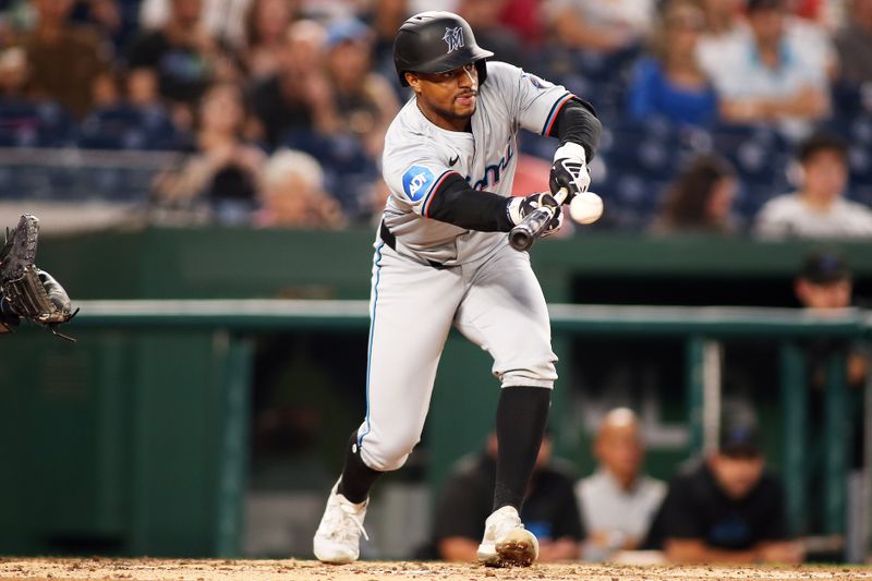 Sep 13, 2024; Washington, District of Columbia, USA; Miami Marlins shortstop Xavier Edwards (63) lays down a bunt for a single during the third inning of a baseball game against the Washington Nationals, at Nationals Park. Mandatory Credit: Daniel Kucin Jr.-Imagn Images

