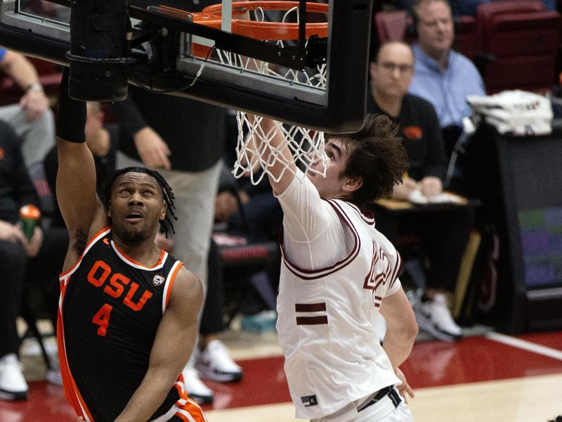 Feb 24, 2024; Stanford, California, USA; Oregon State Beavers guard Dexter Akanno (4) puts up a shot over Stanford Cardinal forward Maxime Raynaud (42) during the second half at Maples Pavilion. Mandatory Credit: D. Ross Cameron-USA TODAY Sports