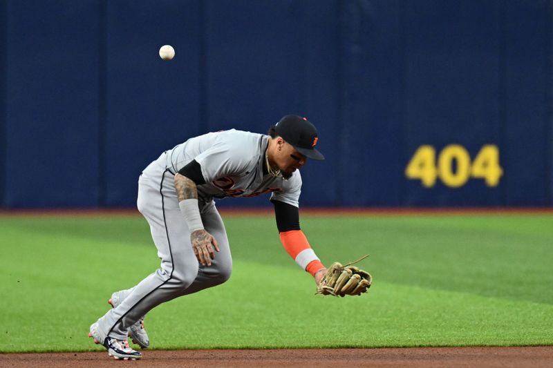 Apr 23, 2024; St. Petersburg, Florida, USA; Detroit Tigers short stop Javier Baez (28) misplays a ground ball in the first inning against the Tampa Bay Rays at Tropicana Field. Mandatory Credit: Jonathan Dyer-USA TODAY Sports