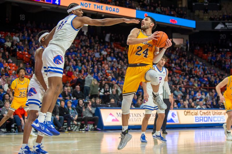 Feb 11, 2023; Boise, Idaho, USA; Wyoming Cowboys guard Hunter Maldonado (24) attempts shot over Boise State Broncos guard Chibuzo Agbo (11) during the first half at ExtraMile Arena. Mandatory Credit: Brian Losness-USA TODAY Sports
