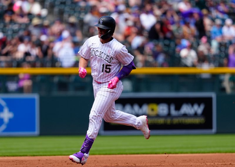May 11, 2025; Denver, Colorado, USA; Colorado Rockies catcher Hunter Goodman (15) runs off his three run home run in the first inning against the San Diego Padres at Coors Field. Mandatory Credit: Ron Chenoy-Imagn Images