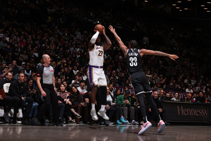 BROOKLYN, NY - MARCH 31: LeBron James #23 of the Los Angeles Lakers shoots a 3-point basket during the game  on March 31, 2024 at Barclays Center in Brooklyn, New York. NOTE TO USER: User expressly acknowledges and agrees that, by downloading and or using this Photograph, user is consenting to the terms and conditions of the Getty Images License Agreement. Mandatory Copyright Notice: Copyright 2024 NBAE (Photo by Nathaniel S. Butler/NBAE via Getty Images)