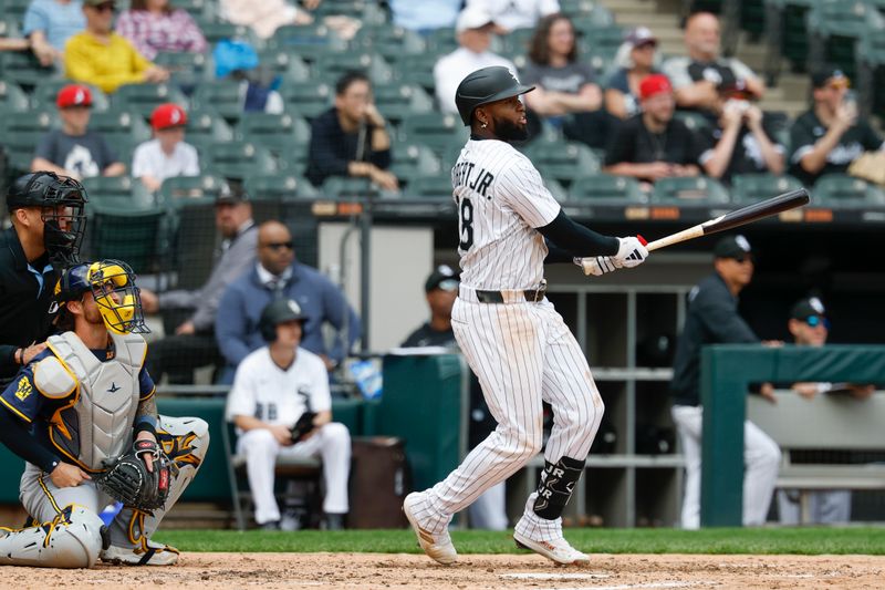 May 1, 2025; Chicago, Illinois, USA; Chicago White Sox center fielder Luis Robert Jr. (88) hits a three-run double against the Milwaukee Brewers during the seventh inning at Rate Field. Mandatory Credit: Kamil Krzaczynski-Imagn Images