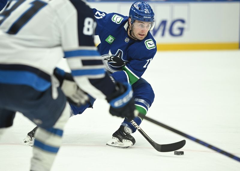 Feb 25, 2026; Vancouver, British Columbia, CAN; Vancouver Canucks left wing Nils Hoglander (21) skates with the puck against Winnipeg Jets first period up at Rogers Arena. Mandatory Credit: Simon Fearn-Imagn Images