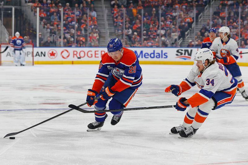 Jan 15, 2026; Edmonton, Alberta, CAN; Edmonton Oilers forward Curtis Lazar (20) controls the puck around New York Islanders defensemen Adam Boqvist (34) during the first period at Rogers Place. Mandatory Credit: Perry Nelson-Imagn Images