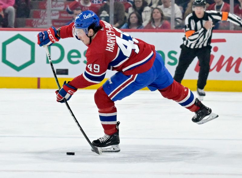 Mar 9, 2024; Montreal, Quebec, CAN; Montreal Canadiens forward Rafael Harvey-Pinard (49) plays the puck during the second period of the game against the Toronto Maple Leafs at the Bell Centre. Mandatory Credit: Eric Bolte-USA TODAY Sports