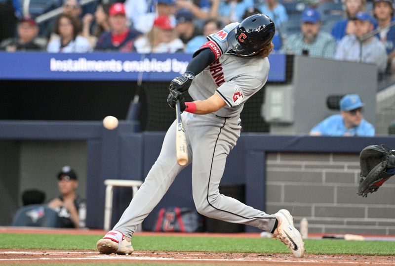 Jun 14, 2024; Toronto, Ontario, CAN;  Cleveland Indians center fielder Daniel Schneemann (10) hits an RBI double against the Toronto Blue Jays in the second inning at Rogers Centre. Mandatory Credit: Dan Hamilton-USA TODAY Sports