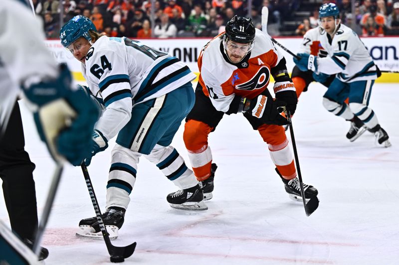 Mar 12, 2024; Philadelphia, Pennsylvania, USA; Philadelphia Flyers right wing Travis Konecny (11) skates around San Jose Sharks center Mikael Granlund (64) after a faceoff in the first period at Wells Fargo Center. Mandatory Credit: Kyle Ross-USA TODAY Sports