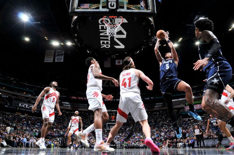 ORLANDO, FL - MARCH 17: Paolo Banchero #5 of the Orlando Magic drives to the basket during the game against the Toronto Raptors on March 17, 2024 at the Kia Center in Orlando, Florida. NOTE TO USER: User expressly acknowledges and agrees that, by downloading and or using this photograph, User is consenting to the terms and conditions of the Getty Images License Agreement. Mandatory Copyright Notice: Copyright 2024 NBAE (Photo by Fernando Medina/NBAE via Getty Images)