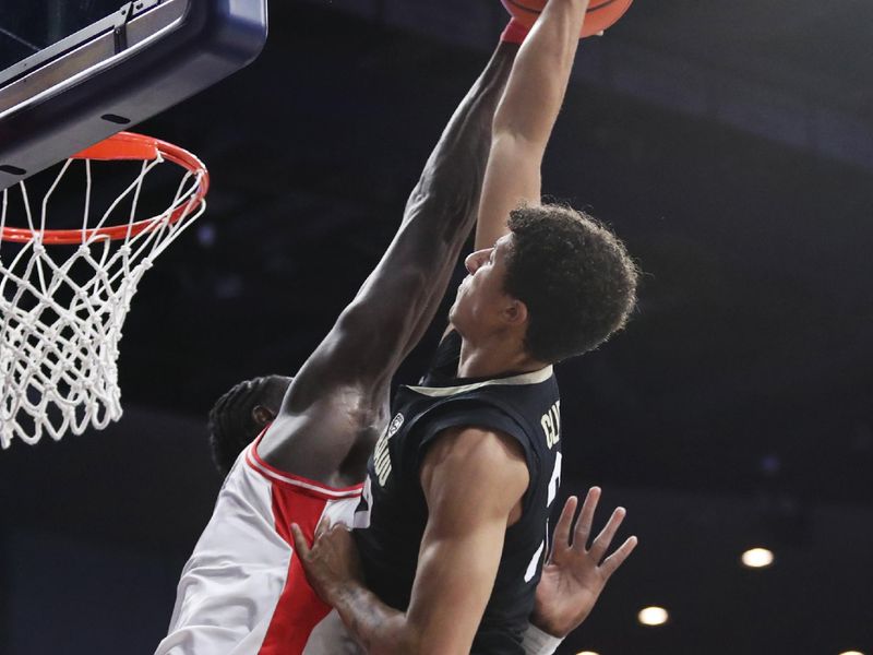 Feb 18, 2023; Tucson, Arizona, USA; Arizona Wildcats center Oumar Ballo (11) blocks a shot against Colorado Buffaloes guard Nique Clifford (32) during the first half at McKale Center. Mandatory Credit: Zachary BonDurant-USA TODAY Sports