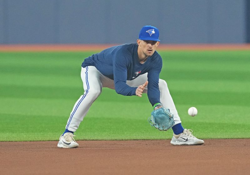 Jun 28, 2023; Toronto, Ontario, CAN; Toronto Blue Jays second baseman Cavan Biggio (8) fields balls during batting practice against the San Francisco Giants at Rogers Centre. Mandatory Credit: Nick Turchiaro-USA TODAY Sports