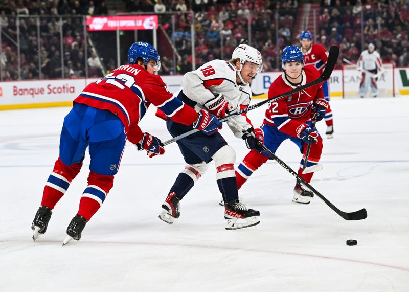 Oct 21, 2023; Montreal, Quebec, CAN; Montreal Canadiens defenseman Justin Barron (52) defends the puck against Washington Capitals defenseman Rasmus Sandin (38) during the first period at Bell Centre. Mandatory Credit: David Kirouac-USA TODAY Sports