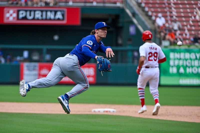 Jul 31, 2024; St. Louis, Missouri, USA;  Texas Rangers relief pitcher Jacob Latz (67) dives and throws to first but is unable to throw out St. Louis Cardinals center fielder Michael Siani (not pictured) during the seventh inning at Busch Stadium. Mandatory Credit: Jeff Curry-USA TODAY Sports