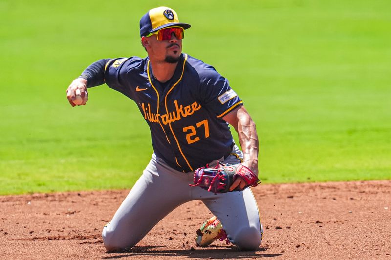 Aug 8, 2024; Cumberland, Georgia, USA; Milwaukee Brewers shortstop Willy Adames (27) tries to recover after committing an error on a ball hit by Atlanta Braves designated hitter Marcell Ozuna (20) (not shown) during the first inning at Truist Park. Mandatory Credit: Dale Zanine-USA TODAY Sports