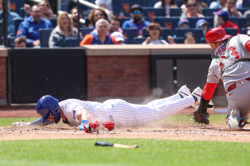 Apr 20, 2025; New York City, New York, USA; New York Mets right fielder Tyrone Taylor (15) slides safely into home plate before being tagged by St. Louis Cardinals catcher Pedro Pages (43) during the third inning at Citi Field. Mandatory Credit: Vincent Carchietta-Imagn Images