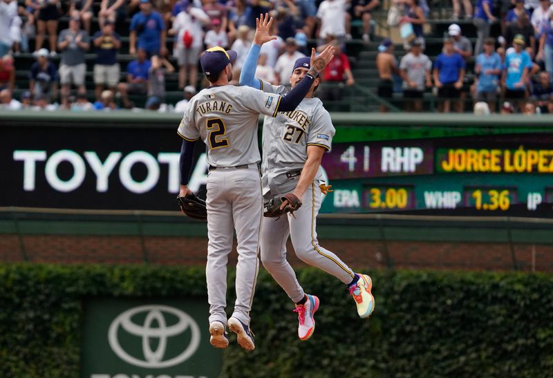 Jul 24, 2024; Chicago, Illinois, USA; Milwaukee Brewers shortstop Willy Adames (27) and second baseman Brice Turang (2) celebrate after defeating the Chicago Cubs at Wrigley Field. Mandatory Credit: David Banks-USA TODAY Sports