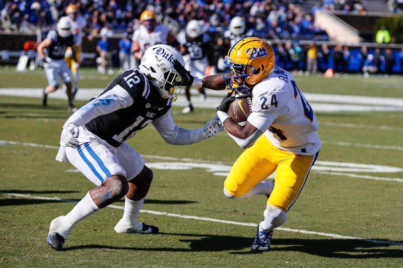 Nov 25, 2023; Durham, North Carolina, USA; Pittsburgh Panthers running back C'Bo Flemister (24) runs with the ball guarded by Duke Blue Devils linebacker Tre Freeman (12) during the first half of the game at Wallace Wade Stadium. Mandatory Credit: Jaylynn Nash-USA TODAY Sports