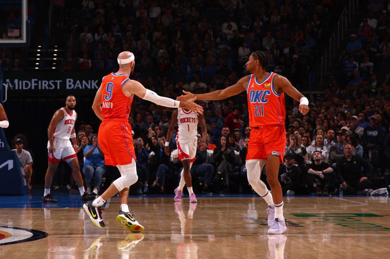 OKLAHOMA CITY, OK - NOVEMBER 8: Aaron Wiggins #21 and Alex Caruso #9 of the Oklahoma City Thunder high five during the game against the Houston Rockets on November 8, 2024 at Paycom Center in Oklahoma City, Oklahoma. NOTE TO USER: User expressly acknowledges and agrees that, by downloading and or using this photograph, User is consenting to the terms and conditions of the Getty Images License Agreement. Mandatory Copyright Notice: Copyright 2024 NBAE (Photo by Zach Beeker/NBAE via Getty Images)