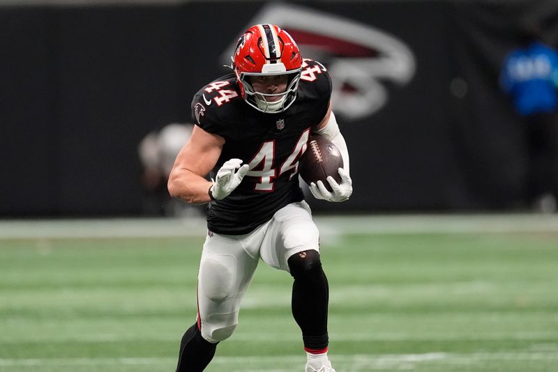 Atlanta Falcons linebacker Troy Andersen (44) runs an interception in for a touchdown against the New Orleans Saints during the first half of an NFL football game, Sunday, Sept. 29, 2024, in Atlanta. (AP Photo/John Bazemore)