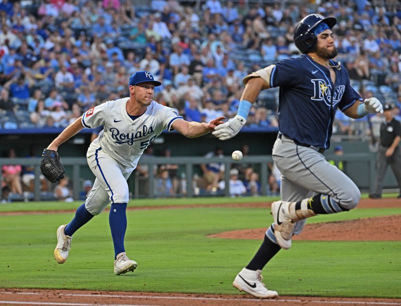 Jun 24, 2025; Kansas City, Missouri, USA;  Kansas City Royals starting pitcher Kris Bubic (50) tosses the ball to first base, with Tampa Bay Rays designated hitter Jonathan Aranda (62) running up the first base line in the fifth inning at Kauffman Stadium. Mandatory Credit: Peter Aiken-Imagn Images
