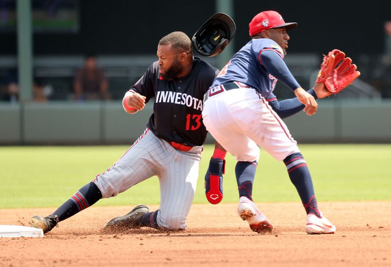 Mar 25, 2024; North Port, Florida, USA; Minnesota Twins left infielder Manuel Margot (13) steals second base as Atlanta Braves infielder Ozzie Albies (1) attempts to tag him out during the second inning at CoolToday Park. Mandatory Credit: Kim Klement Neitzel-USA TODAY Sports