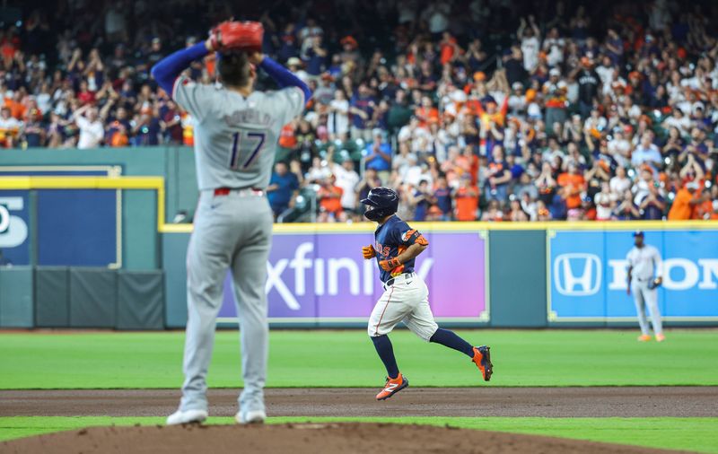 Apr 14, 2024; Houston, Texas, USA; Texas Rangers pitcher Nathan Eovaldi (17) looks on and Houston Astros second baseman Jose Altuve (27) rounds the bases after hitting a home run during the first inning at Minute Maid Park. Mandatory Credit: Troy Taormina-USA TODAY Sports
