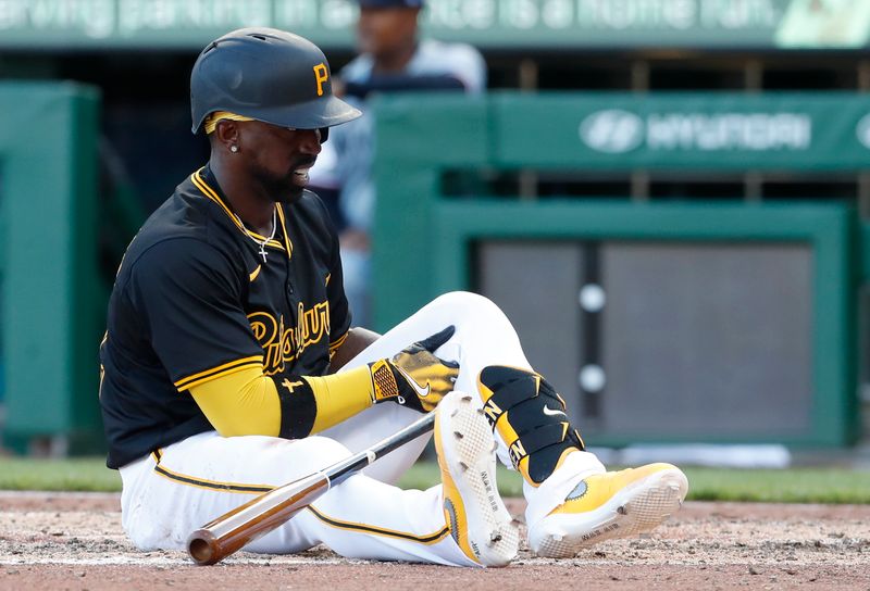 Jun 8, 2024; Pittsburgh, Pennsylvania, USA;  Pittsburgh Pirates designated hitter Andrew McCutchen (22) grabs his knee after falling to the ground to avoid an inside pitch from the Minnesota Twins during the eighth inning at PNC Park. McCutchen would remain in the game. Pittsburgh won 4-0. Mandatory Credit: Charles LeClaire-USA TODAY Sports