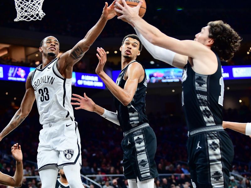 AUSTIN, TX - MARCH 17: Nicolas Claxton #33 of the Brooklyn Nets and Cedi Osman #16 of the San Antonio Spurs go up for a rebound during the game on March 17, 2024 at the Moody Center in Austin, Texas. NOTE TO USER: User expressly acknowledges and agrees that, by downloading and or using this photograph, user is consenting to the terms and conditions of the Getty Images License Agreement. Mandatory Copyright Notice: Copyright 2024 NBAE (Photos by Michael Gonzales/NBAE via Getty Images)