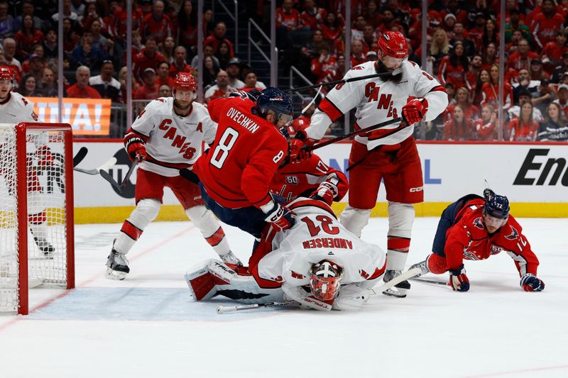 May 15, 2025; Washington, District of Columbia, USA; Washington Capitals left wing Alex Ovechkin (8) flips over the back of Carolina Hurricanes goaltender Frederik Andersen (31) as Anderson covers the puck in the third period in game five of the second round of the 2025 Stanley Cup Playoffs at Capital One Arena. Mandatory Credit: Geoff Burke-Imagn Images